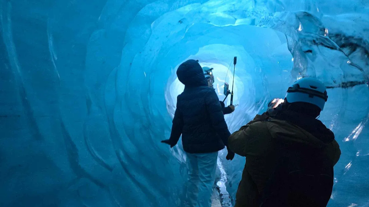Ash-streaked ice ceiling lit by daylight inside the Katla ice cave on the Katlatrack FastTrack Katla ice cave tour, Iceland